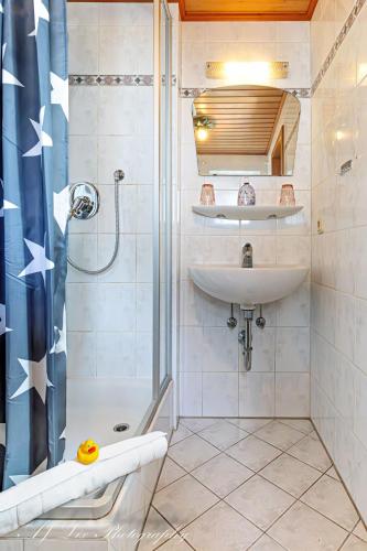 a bathroom with a sink and a shower at Pension Karner in Mittenwald