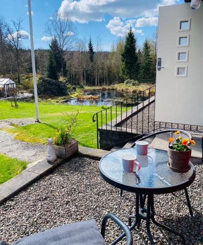 a table with two coffee cups on a patio at Slamrekullen - Ullared in Ullared