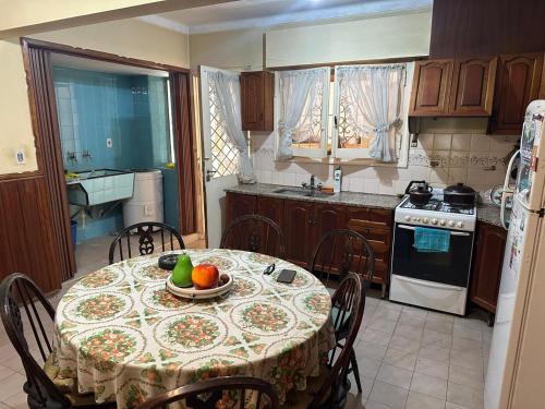 a kitchen with a table with a bowl of fruit on it at CASA PATRICIAS in Godoy Cruz
