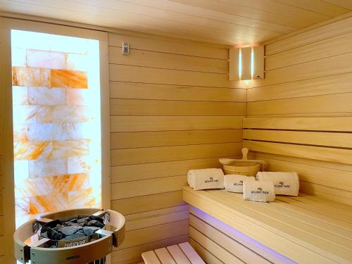 a corner of a sauna with a tub and towels at Belmar Park Resort & SPA in Władysławowo