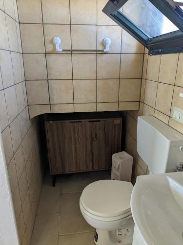 a small bathroom with a toilet and a sink at Attico Nel Verde - Bonsignore in Tricase