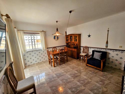 a kitchen and living room with a table and chairs at Oceanic Opulence Delux Apartment in Monte Gordo