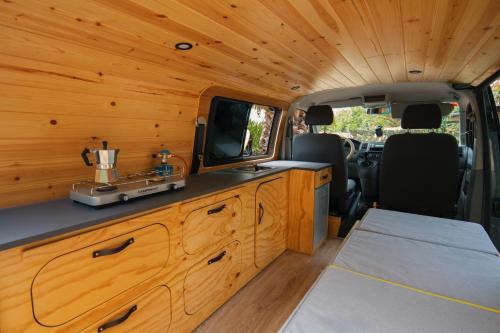 vistas interiores a una cabaña con TV y cocina en Ibiza Camper Vans, en Ibiza