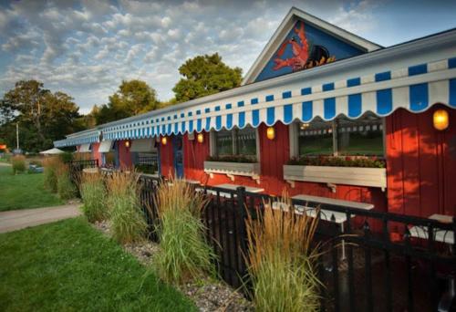 a restaurant with a red and blue building at Elk Rapids Bungalow Garden Firepit AC in Elk Rapids