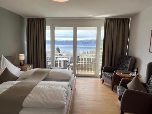 a bedroom with a bed and a view of the ocean at Hotel Landhaus Sternen in Sipplingen