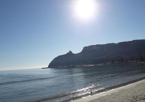a view of a beach with a mountain in the background at Appartamento Sud Sardegna, Cagliari Elesar'sHome in Capoterra