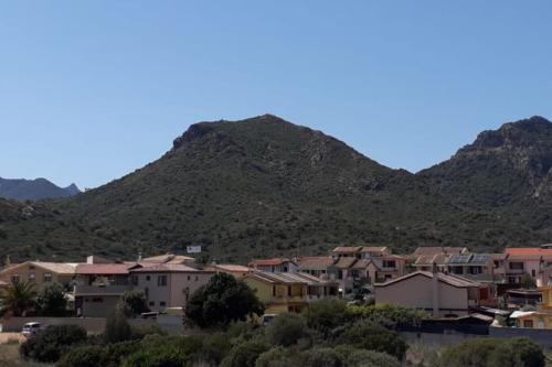 a group of houses in front of a mountain at Appartamento Sud Sardegna, Cagliari Elesar'sHome in Capoterra