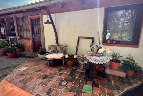 eine Außenterrasse mit einem Tisch, Stühlen und Pflanzen in der Unterkunft Ranch Nana's House in Slovenske Konjice
