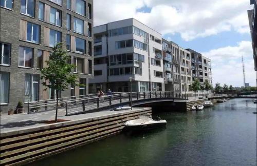 a bridge over a river with buildings and boats at Canal view In City in Copenhagen