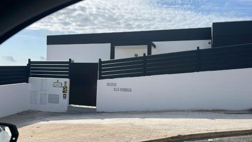 a white and black building with a gate at Quinta Ria Formosa in Olhão