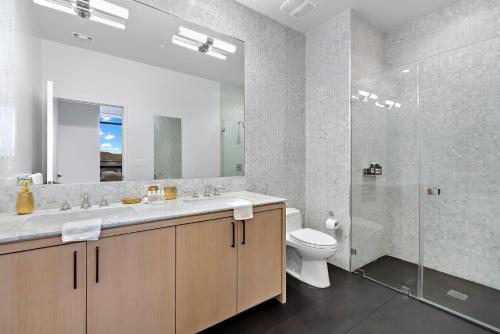 a bathroom with a sink and a toilet and a shower at Skyview 2 Bedroom Penthouse in Los Angeles