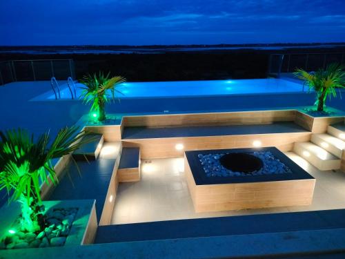 a backyard with a swimming pool at night at Solana's View - Ferienhäuser in ruhiger Lage, mit einer einzigartigen Aussicht, Infinity Pool, Free Parking und Wlan in Ulcinj