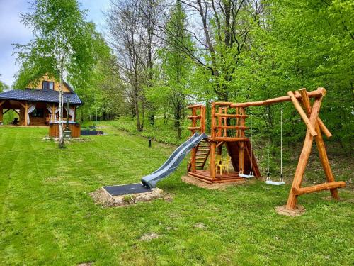 a playground with a slide and a swing set at Zamojskie Bieszczady in Stary Zamość