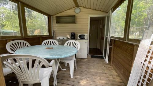 a small kitchen with a table and chairs in a cabin at Camping en Ardeche Le Lion in Bourg-Saint-Andéol