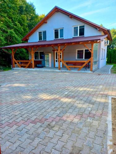 a house with a brick driveway in front of it at Copacabana 1 in Şinteu