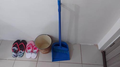 a group of shoes and a broom in a room at Zafreen Staycation/CONDOTEL in Manila