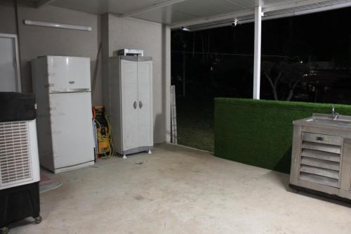 an empty garage with two refrigerators and a table at וילה במעיין in Gid‘ona