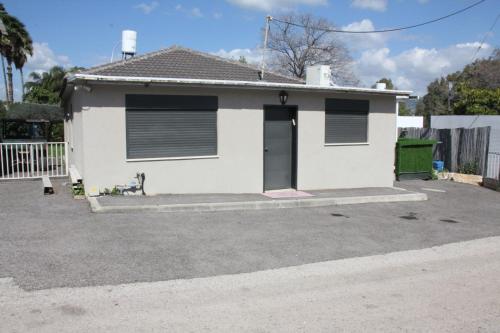 a white house with a door in a driveway at וילה במעיין in Gid‘ona