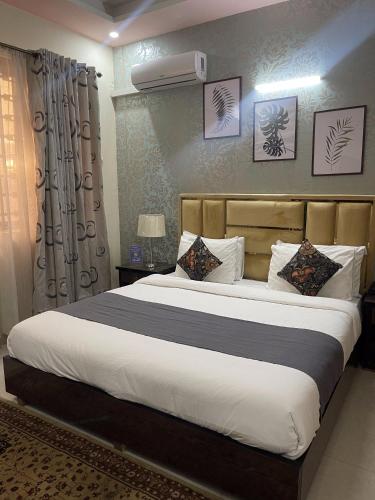 a bedroom with a large bed in a room at Safari Hotel in Islamabad