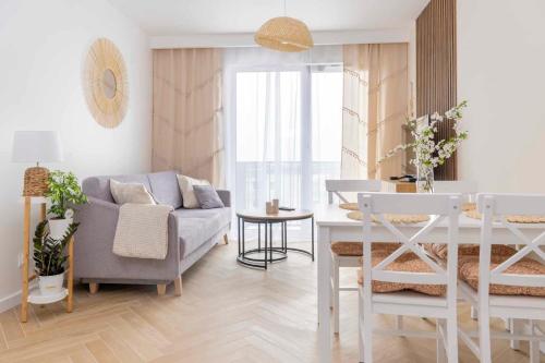 a living room with a couch and a table at APARTAMENT BOHO in Gdańsk