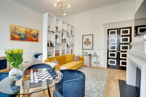 a living room with a chess board on a glass table at Designer Retreat by Green Park in London