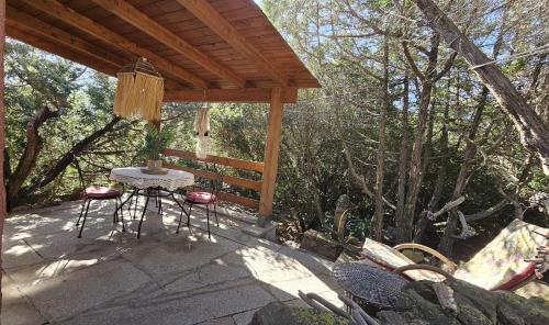 a patio with a table and chairs under a pavilion at Sardinian Seaside Retreats in Badesi