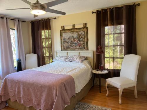 a bedroom with a bed and a painting on the wall at tropical bay house in Englewood