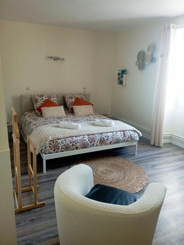 une chambre avec un lit et une chaise dans l'établissement gite du puits, à Bernières-dʼAilly