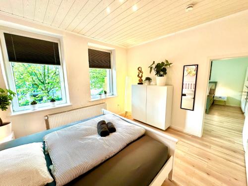 a bedroom with a bed and two windows at Akram Appartement IV - Nähe Bahnhof in Hildesheim