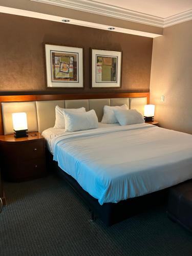 a large bed in a hotel room with two lamps at MGM Signature studio No resort fee in Las Vegas