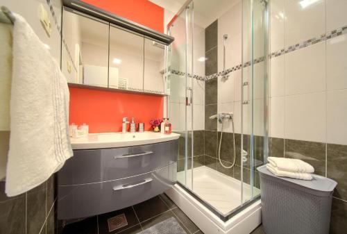 a bathroom with a glass shower and a sink at Apartmani ASSA Krk in Krk