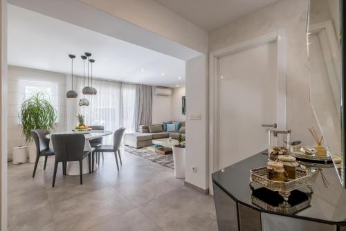 a dining room and living room with a table and chairs at Luxury Apartment Anna in Split