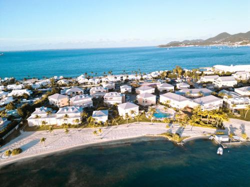 an aerial view of a resort next to the ocean at Condo Enjoy in Baie Nettle