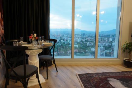 a table in a room with a large window at Royal Kate SPA included 32nd floor in Skopje