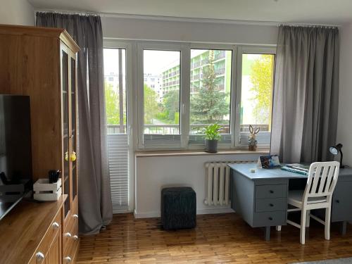 Habitación con escritorio y ventana. en Apartament Centrum, en Suwałki