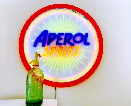 a sign for aarma spill with a bottle on a table at Panorama di mare suite via Cima Cagliari Centro in Cagliari