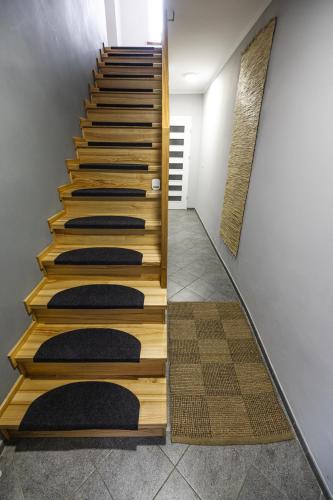 a set of stairs with black mats on them at Domek przy Rynku in Głogówek