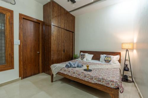 a bedroom with a bed with a wooden headboard at Dhruva - Luxury Villa in CBD in Dehradun