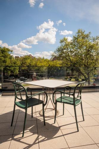 a table and two chairs sitting on a patio at Basch House 1887 Rooms, Subotica in Subotica