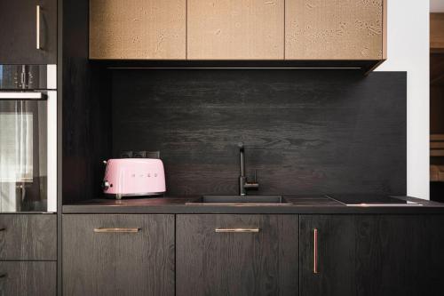 a kitchen with a sink and a toaster on the counter at Pension Haus Tirol in Laion