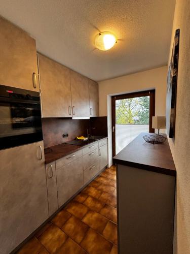 a kitchen with stainless steel cabinets and a black counter top at Ferienwohnung Claudia in Oberammergau