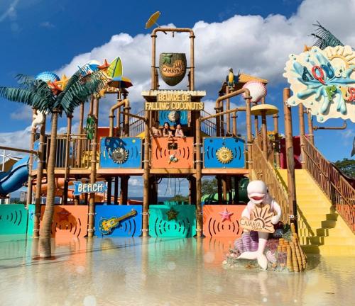 a child sitting in front of a water park at Casa Amores: Camaya Coast in Mariveles