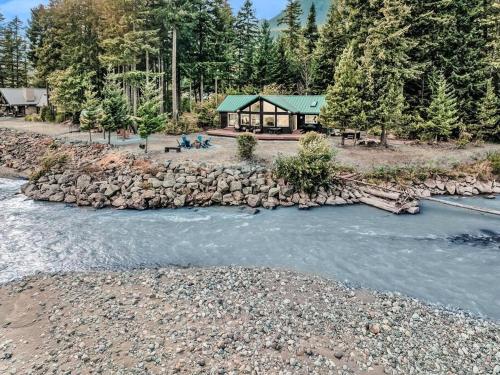 an aerial view of a river with a cabin at The River House- Riverfront Cabin-hot tub, gazebo! in Packwood