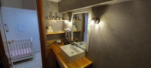 a bathroom with a sink and a mirror at Rania's house in Aigio