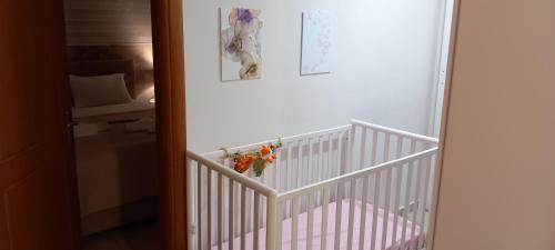 a white crib with flowers on it in a room at Rania's house in Aigio