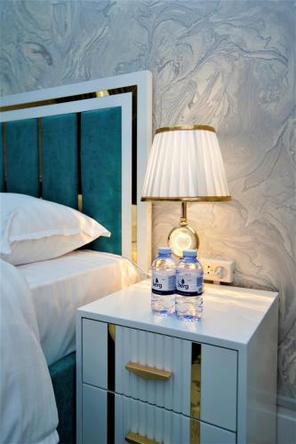 a table with water bottles on it next to a bed at Next Hotel Samarkand in Samarkand