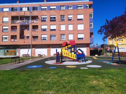 a playground in a park in front of a building at TXIMELETA Haro in Haro
