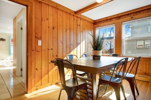 a wooden dining room with a table and chairs at Seaside Serenity: Charming 2BR Escape - Parking in Scarborough