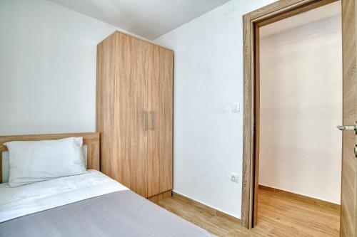 a bedroom with a bed and a closet at Apartments Pavic in Risan