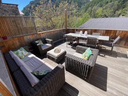 a patio with couches and a table and a table and chairs at Village de Guillaumes Appartement avec terrasse in Guillaumes
